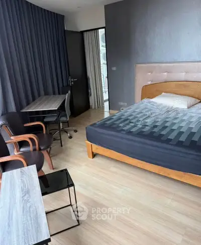 Modern bedroom with stylish furniture and natural light, perfect for a cozy living experience.