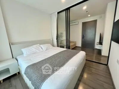 Modern bedroom with sliding glass doors and cozy decor