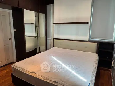 Cozy bedroom with modern furnishings and ample storage space