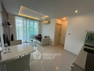 Modern living room with sleek design and natural light, featuring a cozy sofa and dining area.