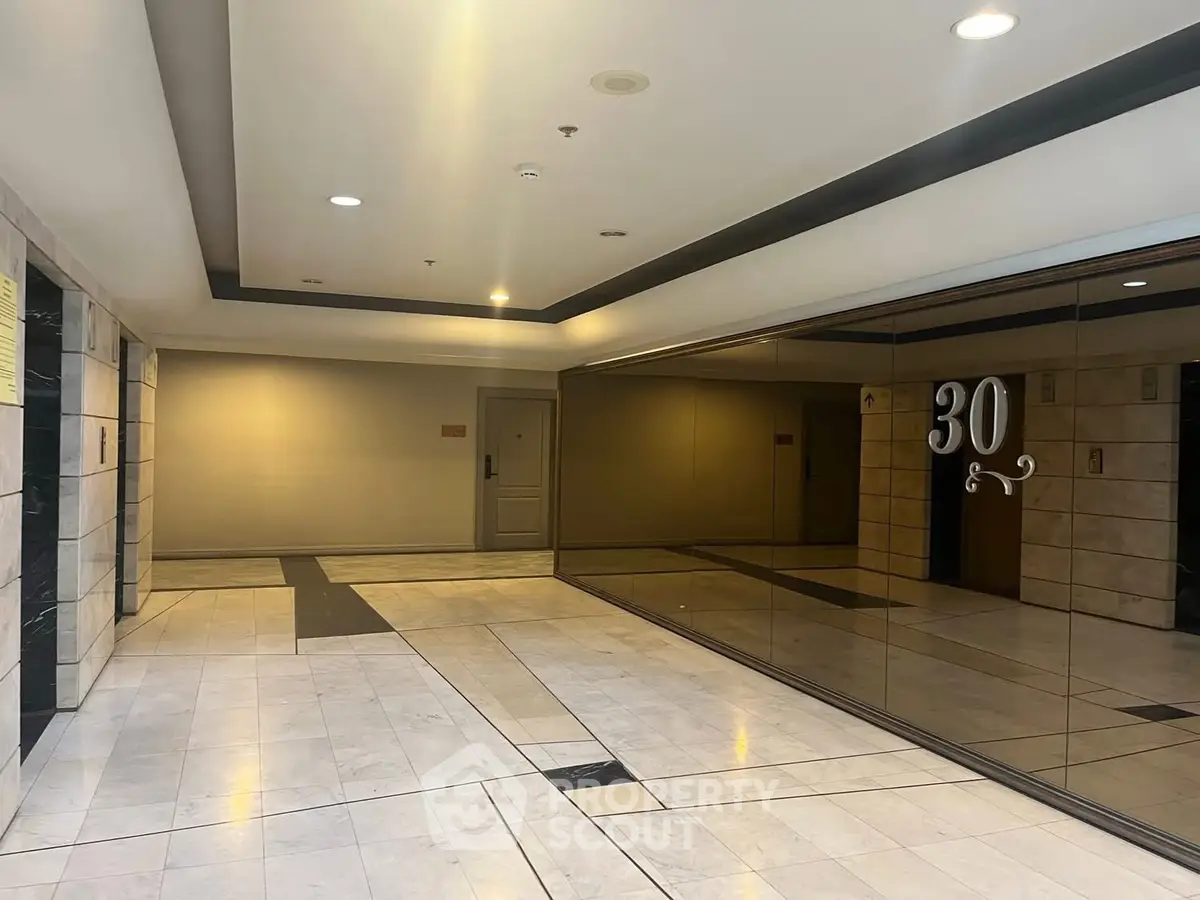 Spacious modern building entrance with elegant marble flooring and glass walls