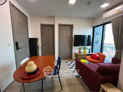 Modern living room with vibrant decor and balcony view in a stylish apartment.