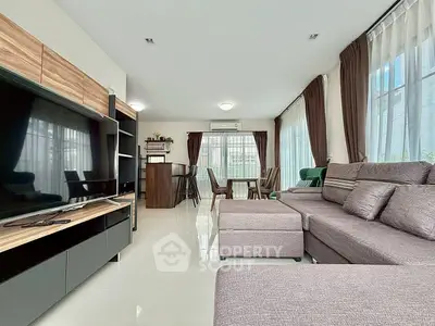 Spacious modern living room with large windows and stylish furniture