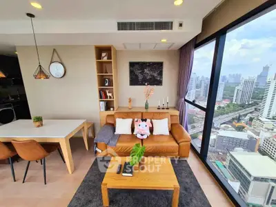 Modern living room with stunning city view, featuring cozy leather sofa and stylish decor in high-rise apartment.