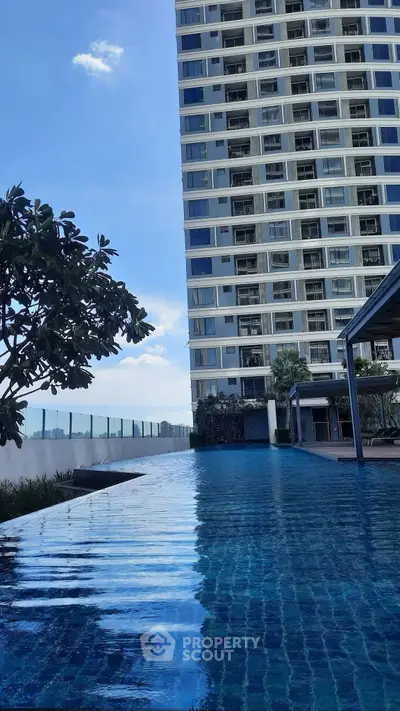 Luxurious high-rise building with stunning rooftop pool and panoramic city views.