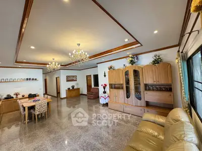 Spacious living room with elegant chandeliers and comfortable seating