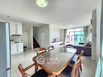 Spacious open-plan living and dining area with modern furnishings and natural light.