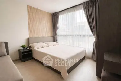 Modern bedroom with large window and stylish decor in urban apartment