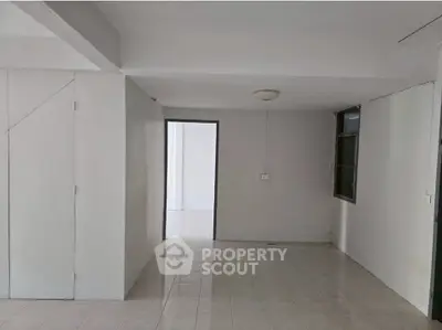 Spacious interior with tiled flooring and neutral walls, ideal for customization.