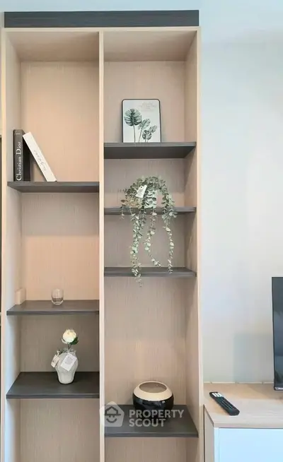 Modern minimalist bookshelf with decorative items in stylish living room.