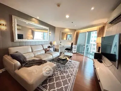 Luxurious living room with modern decor and spacious balcony view.