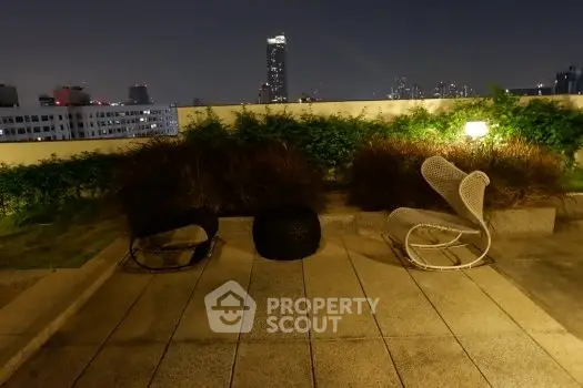 Stunning rooftop view with modern outdoor seating and city skyline backdrop.