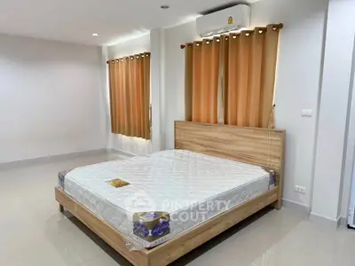 Spacious bedroom with modern bed and natural light