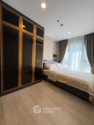 Modern bedroom with large wardrobe and natural light