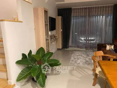 Modern living room with stylish furniture and large window, perfect for cozy evenings.