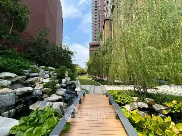Serene garden pathway with lush greenery and modern building backdrop