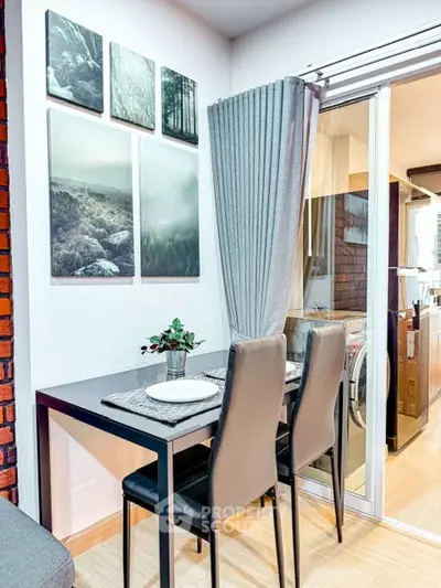 Modern dining area with stylish decor and sliding glass door to laundry space