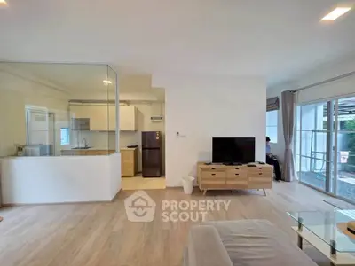 Spacious modern living room with open kitchen and large windows