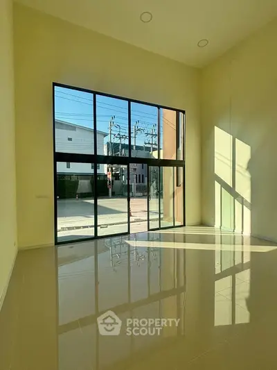 Spacious modern living room with large windows and abundant natural light