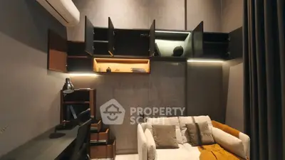 Modern living room with stylish shelving and cozy sofa in a contemporary apartment.