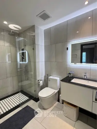 Luxurious modern bathroom with glass shower and elegant vanity