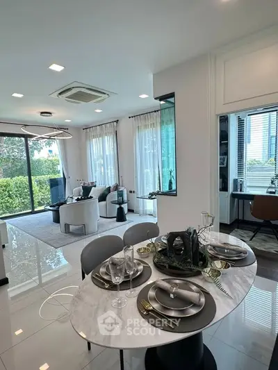 Luxurious open-plan living room with elegant dining area and garden view, perfect for modern living.
