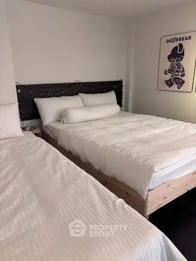 Cozy bedroom with two beds and stylish decor, perfect for restful nights.