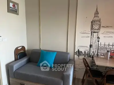 Cozy living room with modern sofa and stylish wall art featuring iconic cityscape.