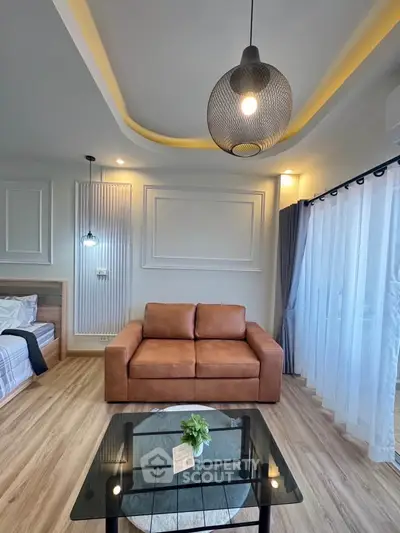 Modern living room with stylish lighting and cozy sofa, featuring elegant decor and natural light.