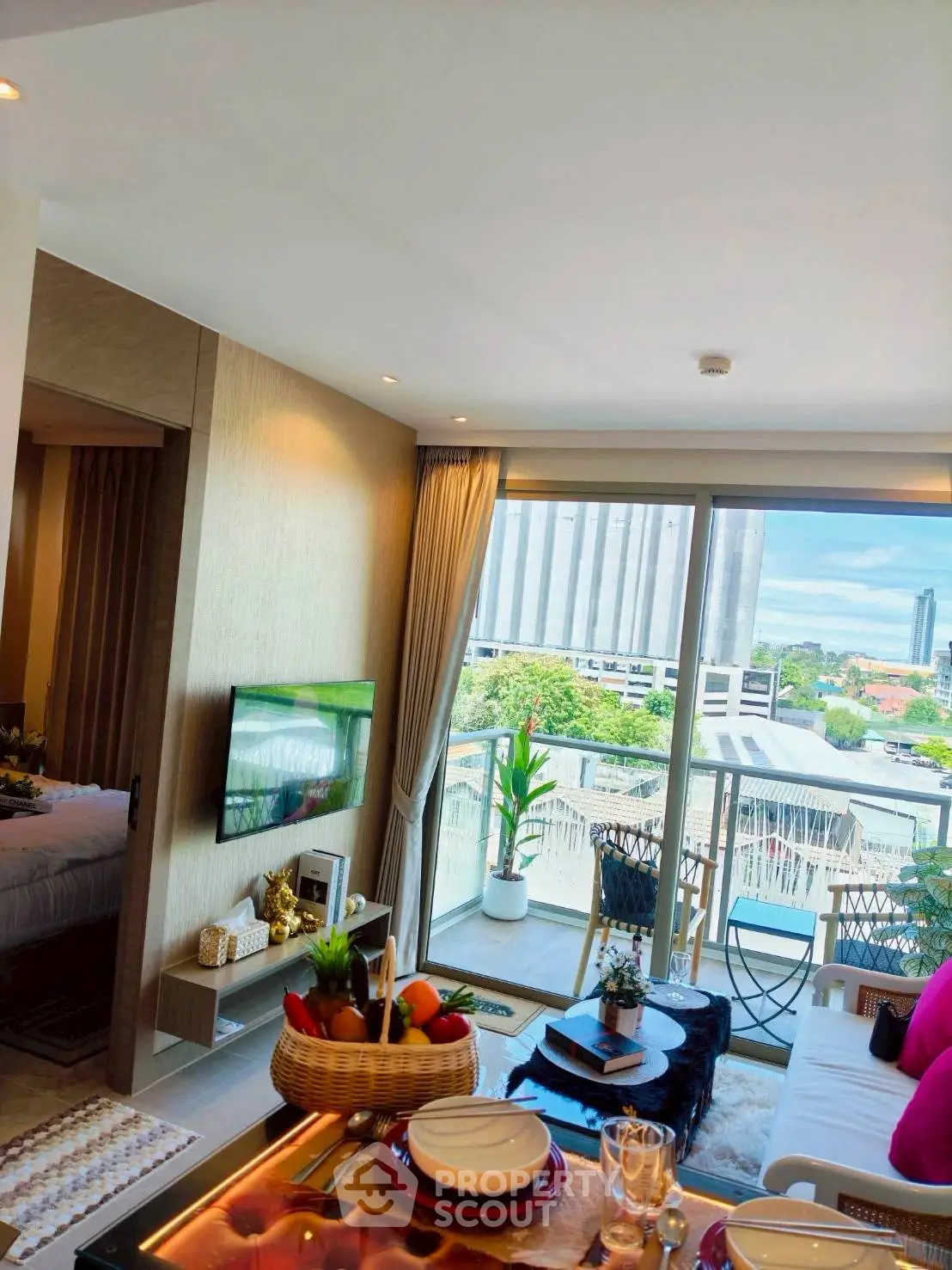 Modern living room with balcony view in a stylish apartment, featuring elegant decor and abundant natural light.