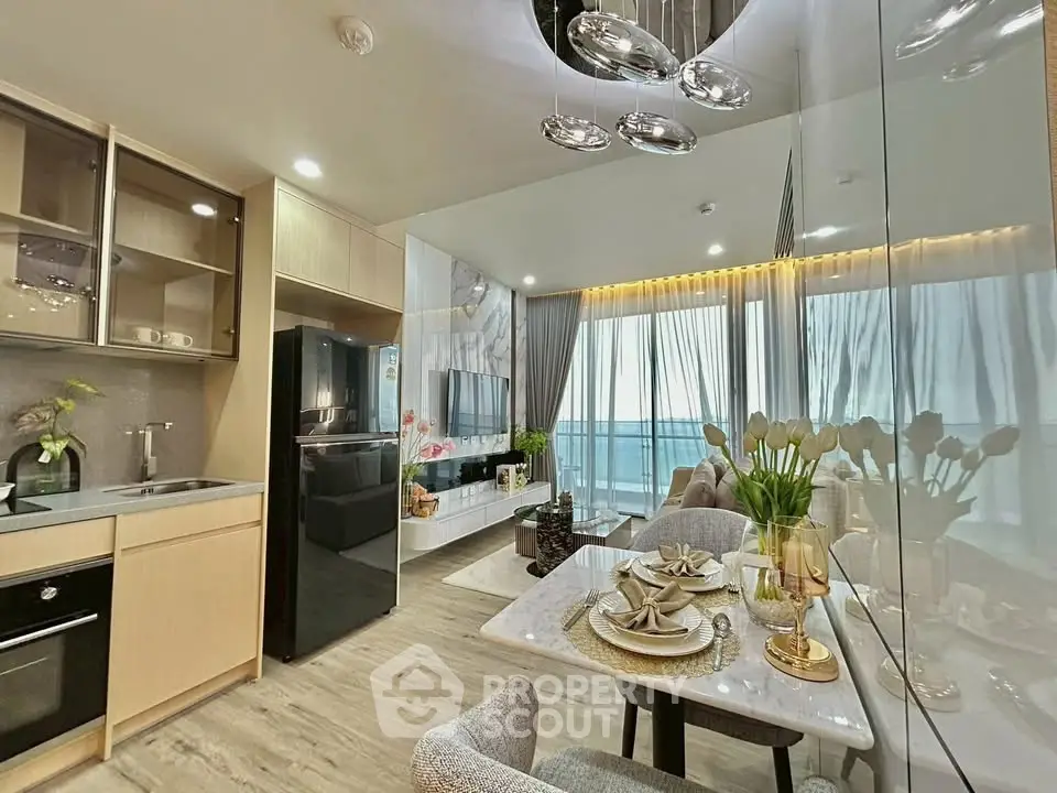 Modern open-plan kitchen and dining area with elegant decor and large windows.