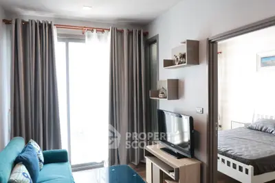 Modern living room with cozy sofa and TV, adjacent to a stylish bedroom