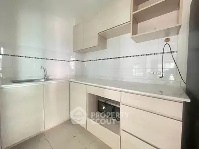 Modern kitchen with sleek cabinetry and built-in microwave