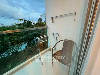 Charming balcony with lush greenery view, perfect for relaxation and outdoor enjoyment.