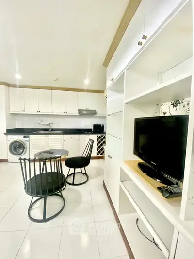 Charming open-layout kitchen with dining area and modern appliances in a cozy apartment.
