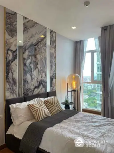 Luxurious bedroom with marble accent wall and city view