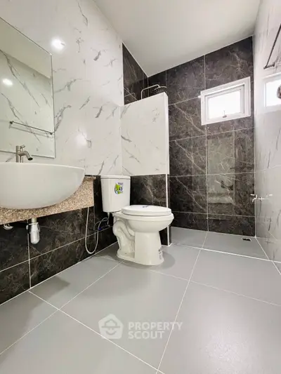 Modern bathroom with sleek tiles and contemporary fixtures