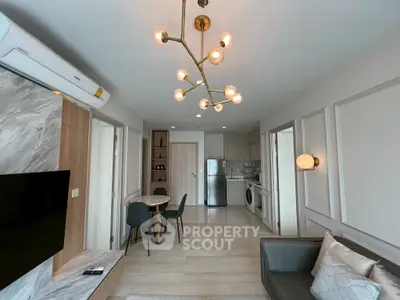 Modern living room with stylish lighting and open kitchen layout