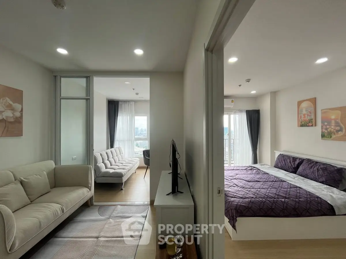 Modern apartment with cozy living room and elegant bedroom, featuring stylish decor and ample natural light.