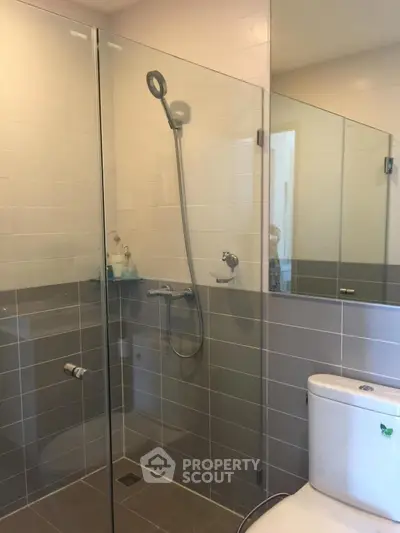 Modern bathroom with glass shower enclosure and sleek fixtures