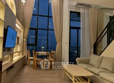 Luxurious high-ceiling living room with large windows and elegant decor