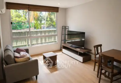 Bright and cozy living room with modern furniture and large window view.