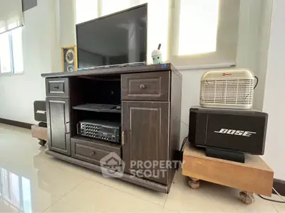 Stylish living room with modern entertainment center and premium sound system.