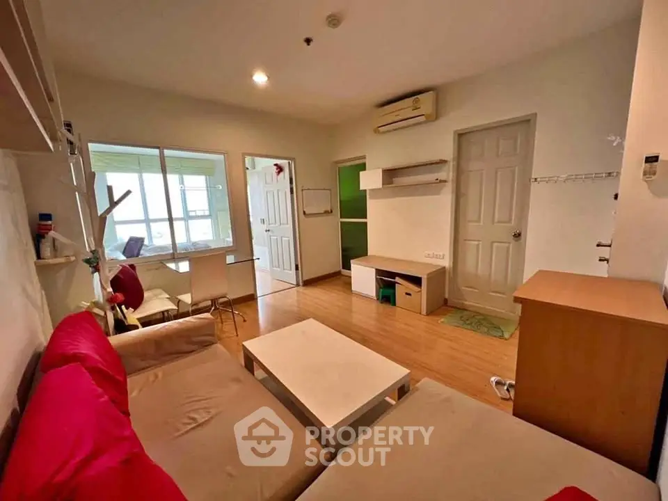 Cozy living room with modern decor and natural light, perfect for relaxation and entertainment.