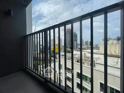 Spacious balcony with city skyline view, perfect for urban living enthusiasts.