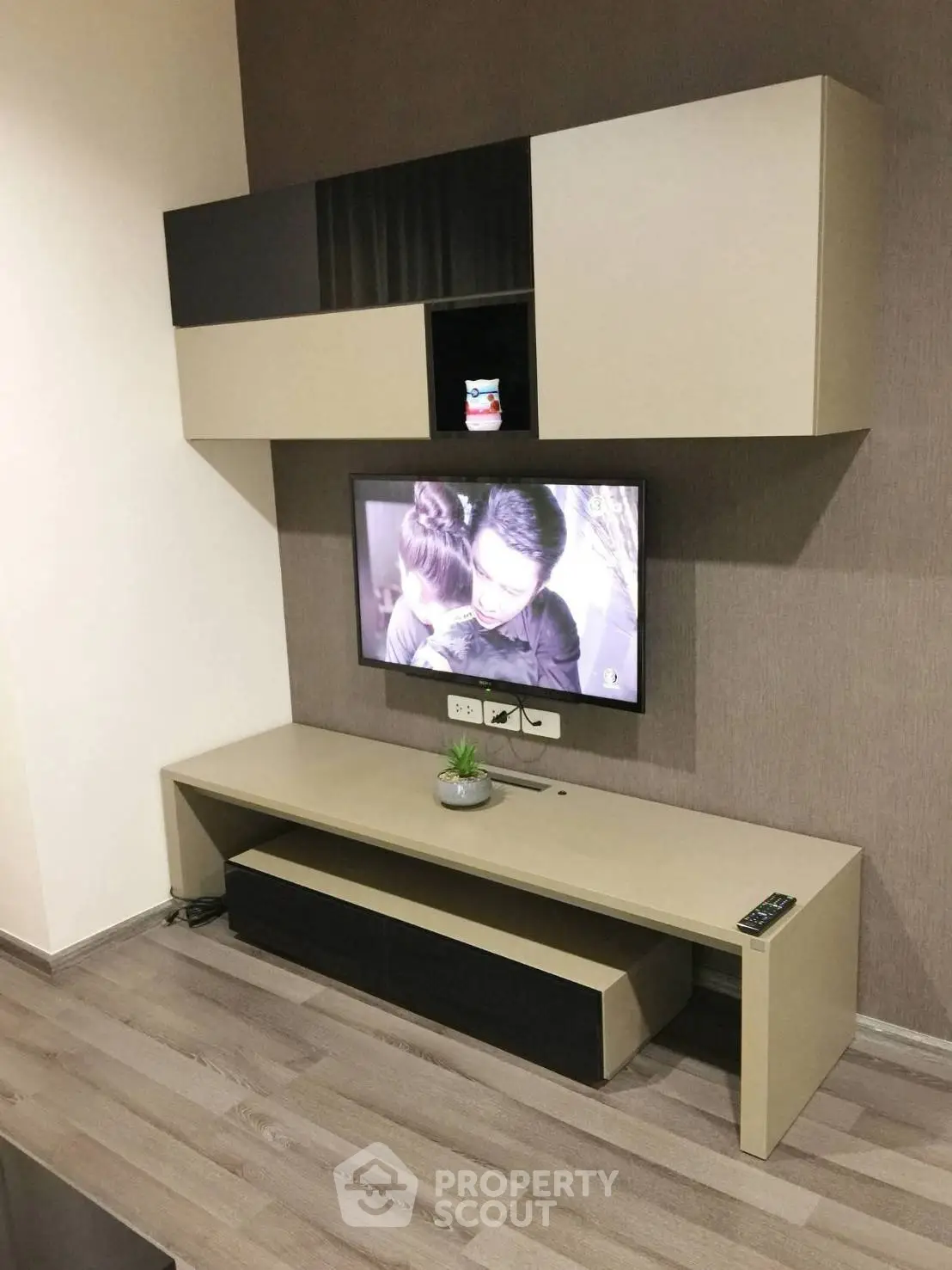 Modern living room with sleek TV unit and stylish wall-mounted cabinets