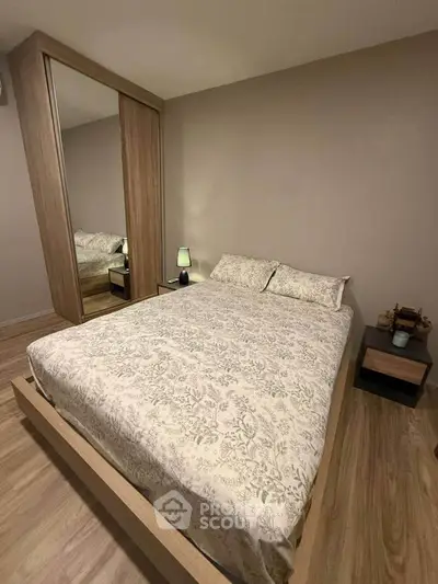 Cozy bedroom with elegant wooden flooring and mirrored wardrobe