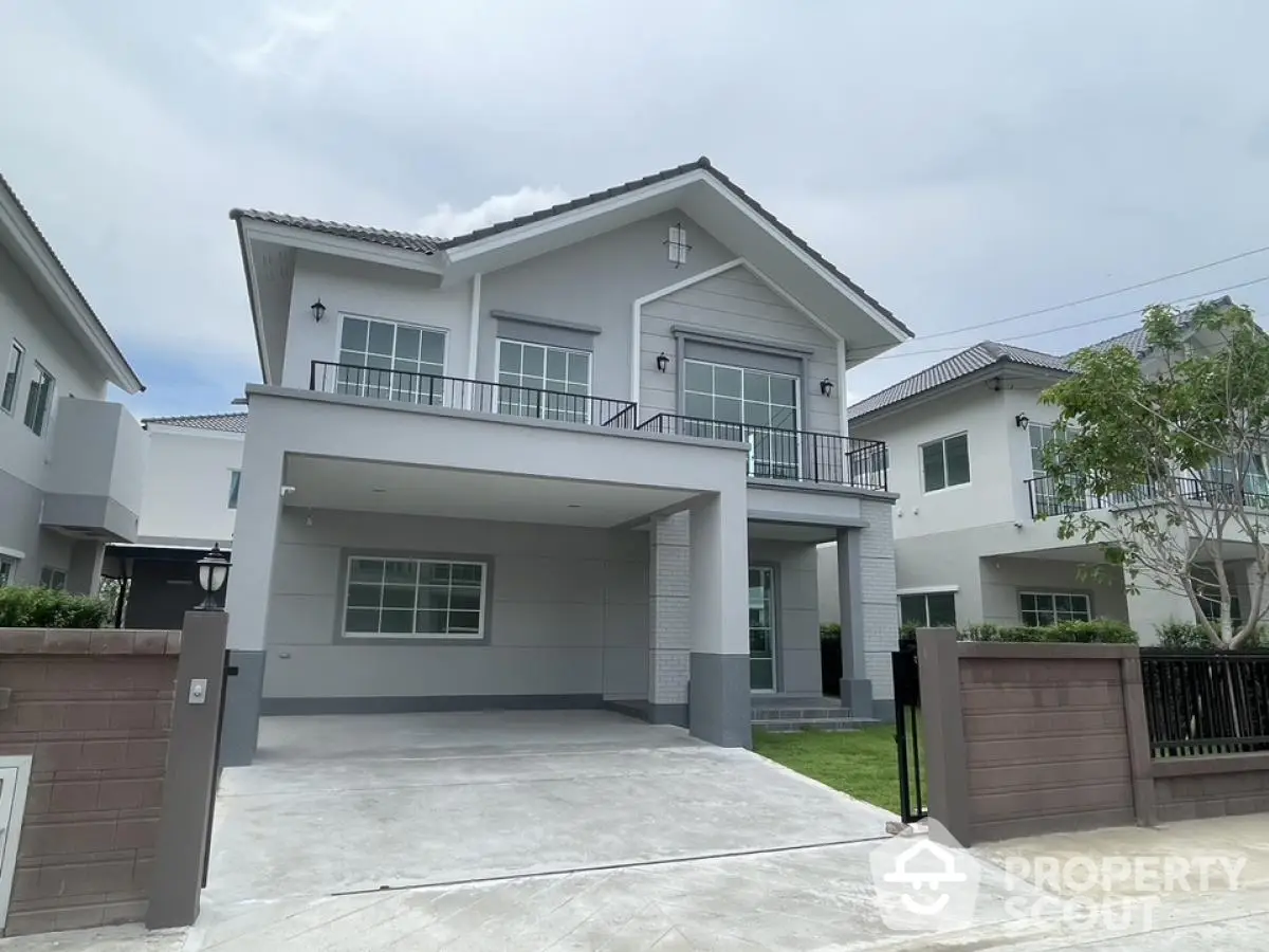 Modern two-story house with spacious driveway and elegant facade