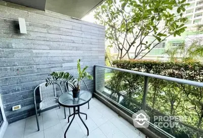 Spacious balcony with modern grey tiles, comfortable seating, and lush greenery offering a serene outdoor retreat in a high-rise apartment.