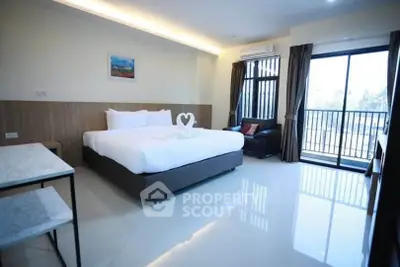 Spacious modern bedroom with balcony and elegant decor